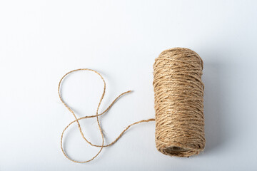 Spool rope on white background. Isolated. Embroidery thread yarn isolated, wool knitting.