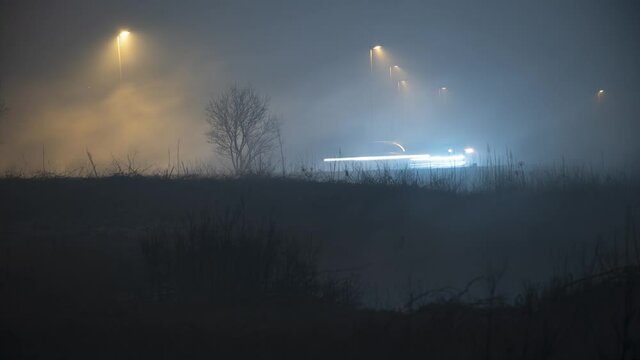 Traffic and street lamps in dense swamp fog Reykjavik Iceland
