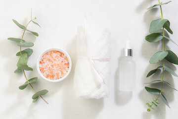 Fototapeta na wymiar Natural ingredients for skin care and spa on white marble background wit aromatic eucalyptus twigs.