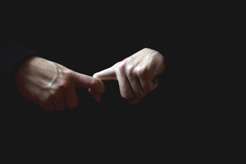 male hand on a dark background
