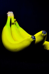 Bunch of bananas on black background © Daniel