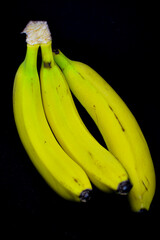 Bunch of bananas on black background © Daniel