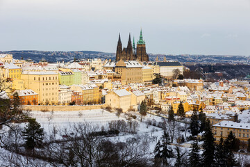 Snowy Prague City with gothic Castle from Hill Petrin in the sunny Day, Czech republic