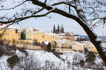 Snowy Prague City with gothic Castle from Hill Petrin in the sunny Day, Czech republic
