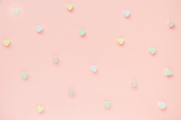 Romantic abstract apricot pink backround with woooden hearts decoration. Love, dating and Valentines Day concept, copy space