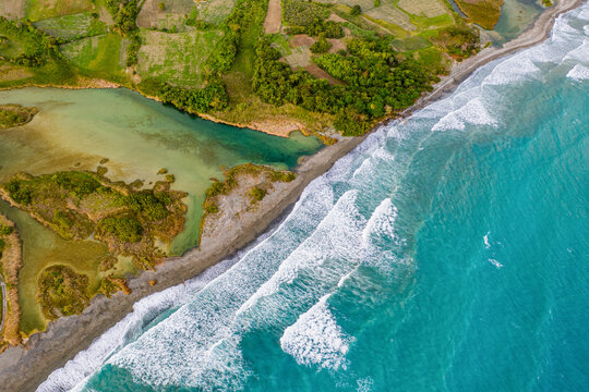Aerial view of strong waves at Patos Beach at the mouth of the Rio Nizao during the golden hour, Nizao, Peravia, Dominican Republic
