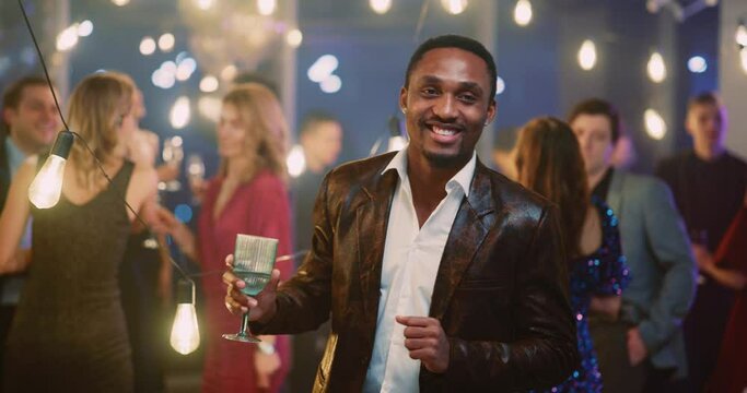 Afro-American Happy Positive Man Dancing with Alcohol Drink Socializing with Multi-Ethnic Friends Celebrating Corporate Party Holiday in Conference Hall.