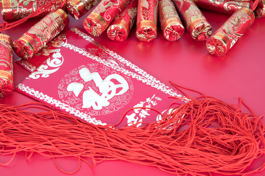 Festive decorations and red envelopes on a red background