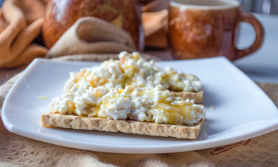 breakfast of bread with cottage cheese and honey