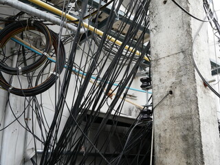messy of electrical wires and internet fiber signal line on electric poles.