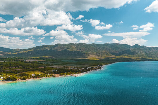 Aerial view of the coastline near the green mountains in a cloudy day, Ocoa, Azua, Dominican Republic