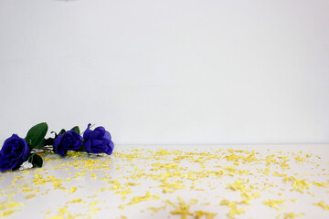 Blue roses and yellow potpurri over white background