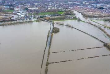 Aerial drone photo of the town of Allerton Bywater near Castleford in Leeds West Yorkshire showing the flooded fields and farm house from the River Aire during a large flood after a storm.