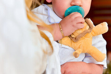 close up of baby holding green pacifier, pacifier baby, nursing nipple