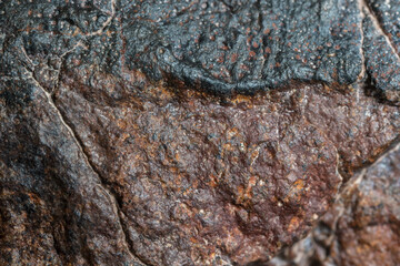 Macro photo of the fusion crust from a Chondrite Meteorite, piece of rock formed in outer space in...