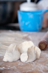 Fototapeta na wymiar Dumplings wrapped on the chopping board