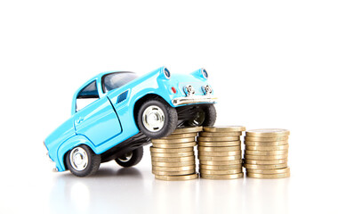 Car model climbing on euro coin on white background