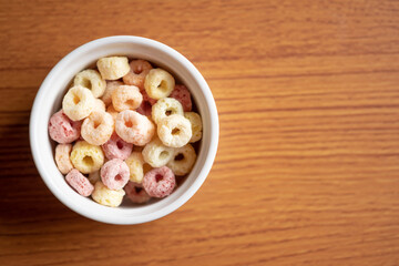 Cereal flakes in bowl ceramic with copy space,Breakfast concept.Food with delicious fruity taste and fruity colours.It's made with maize,wheat,and barley.