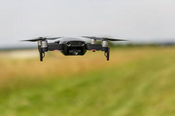 Fototapeta na wymiar Quadcopter with digital camera in flight. Drone in the film industry. Broadcast and record with a digital quadcopter camera.