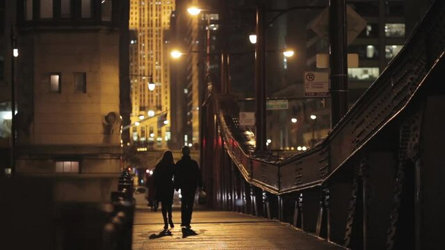 Couple walking across a bridge in Chicago