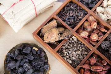 Traditional Chinese medicine Polygonum multiflorum in scales and various herbs in checkerboard boxes