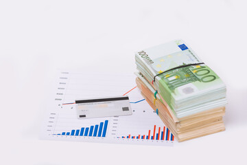 Euro cash currency on a graphic chart and a pen on it