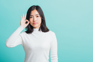 woman smiling and showing hand the OK sign