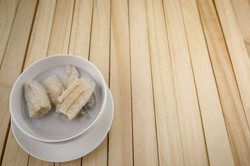 Banana in Coconut Milk.Dessert of Thailand Placed on a wooden background.