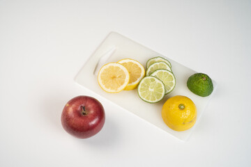 Sliced lemon and lime on cutting board 