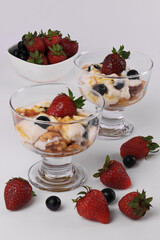 Vanilla Ice Cream topped with Strawberries , Blueberries and  caramel syrup with Walnuts