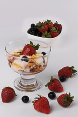 Vanilla Ice Cream topped with Strawberries , Blueberries and  caramel syrup with Walnuts