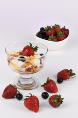Vanilla Ice Cream topped with Strawberries , Blueberries and  caramel syrup with Walnuts