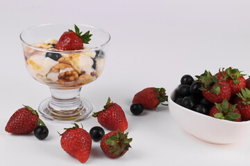 Vanilla Ice Cream topped with Strawberries , Blueberries and  caramel syrup with Walnuts