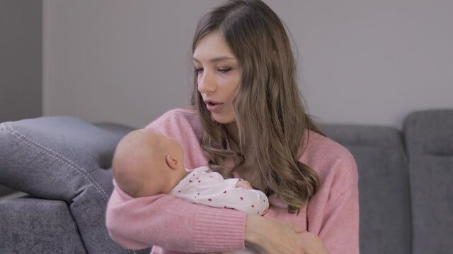 A mother tries to comfort her crying baby.