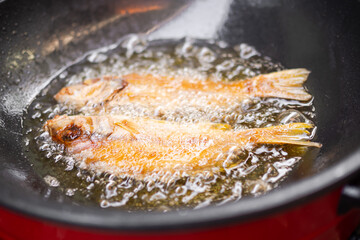 Fish fry with oil in pan. food for health concept.