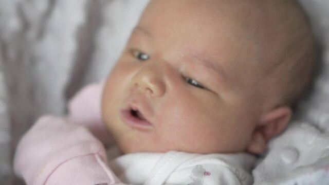 Beautiful Caucasian Newborn Baby Girl With Pink Mittens - close up shot