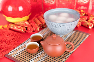 A bowl of dumplings and tea on the festive background