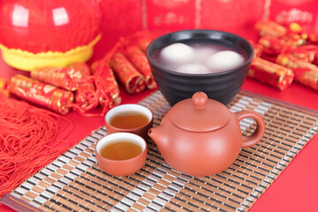 A bowl of dumplings and tea on the festive background