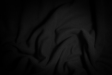 Fototapeta premium Abstract vignette folded black cloth background.