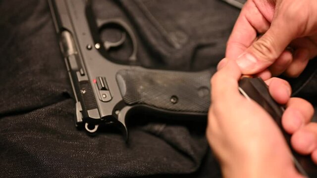 Loading self defense rounds in a magazine of a concealed carry gun and putting gun in a holster