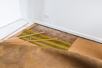 ripping up the carpet and underlay revealing floorboard in home interior renovation project, DIY...
