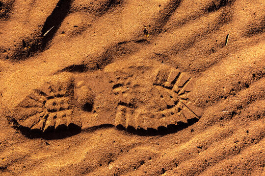 footprint with tread shoes on a sandy surface in Brazil