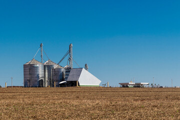 silver silos on agro manufacturing plant for processing drying cleaning and storage of agricultural products, flour, cereals and grain. Large iron barrels of grain. Granary elevator in Brazil © AlfRibeiro
