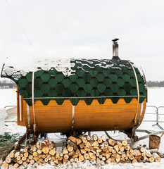 Mobile bath in the form of a wooden barrel near, Mobile winter steam room