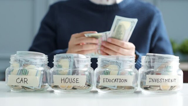 Hand's man putting money in jar for future, money plan, save money and management concept