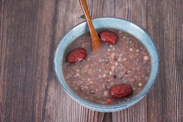 Overlooking a bowl of eight treasures porridge and wooden spoon - obrazy, fototapety, plakaty