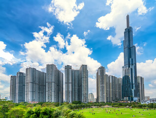 Fototapeta premium Skyscrapers viewed from below towards sky represents urban development with modern architecture to bring international in Ho Chi Minh City, Vietnam