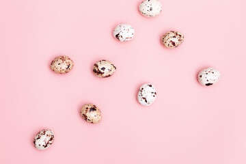 Easter Quail eggs pink colored. Spring Easter composition with chocolate food. Monochrome image, minimal style.