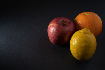 Some fruits on a black background
