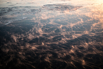 Icy water of st lawrence river evaporates as the temperature rises with the sunrise making a smoky...